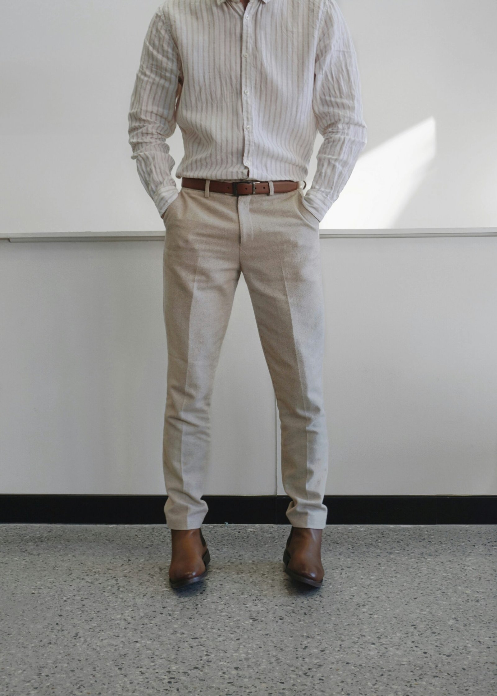 man in white and gray pinstripe dress shirt and white pants